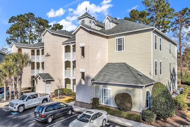 view of property featuring uncovered parking