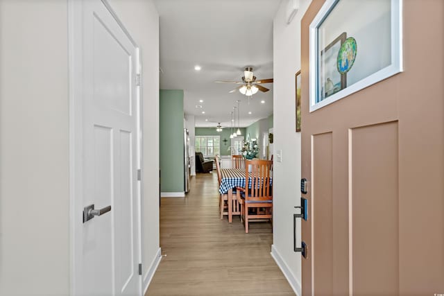 foyer entrance featuring light wood finished floors, ceiling fan, baseboards, and recessed lighting