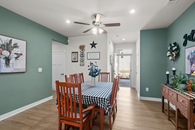 dining area featuring light wood-style flooring, visible vents, and baseboards