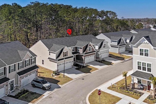 drone / aerial view with a residential view and a view of trees