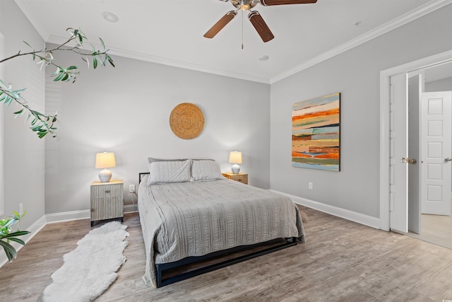 bedroom with baseboards, ornamental molding, ceiling fan, and wood finished floors