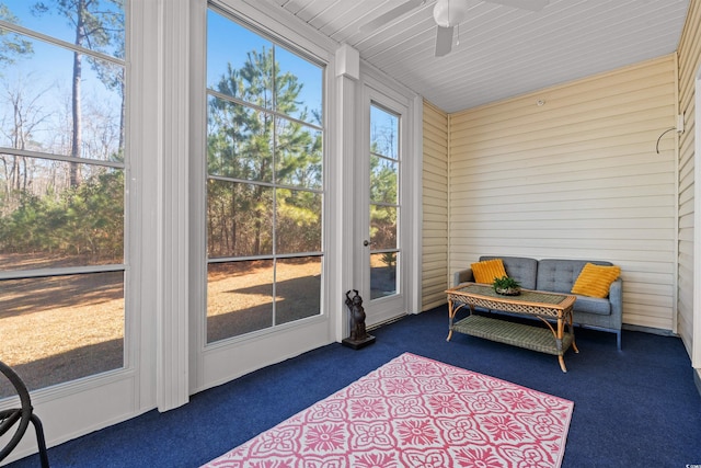 sunroom / solarium featuring ceiling fan