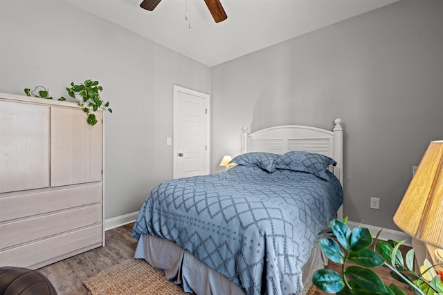 bedroom featuring ceiling fan, baseboards, and wood finished floors