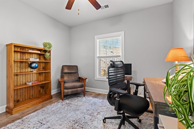 office area with visible vents, wood finished floors, a ceiling fan, and baseboards