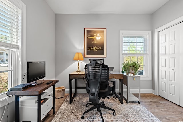 office space featuring baseboards and wood finished floors