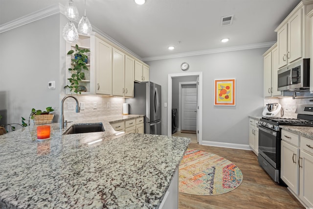 kitchen featuring visible vents, a peninsula, stainless steel appliances, open shelves, and a sink