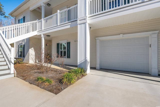 entrance to property featuring driveway and an attached garage