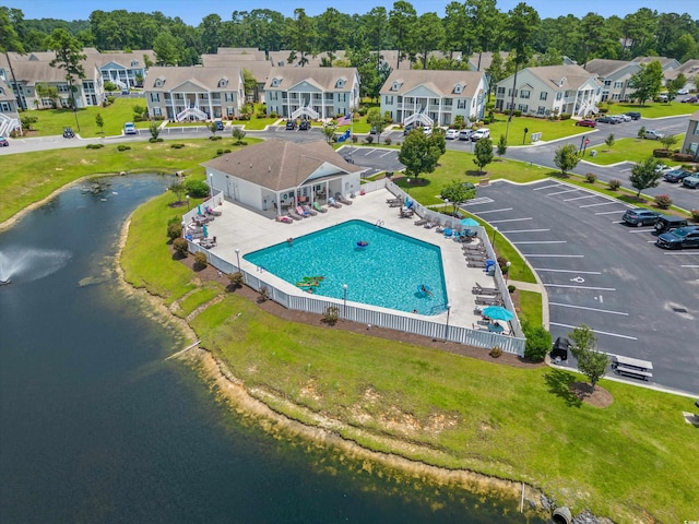 birds eye view of property featuring a water view and a residential view