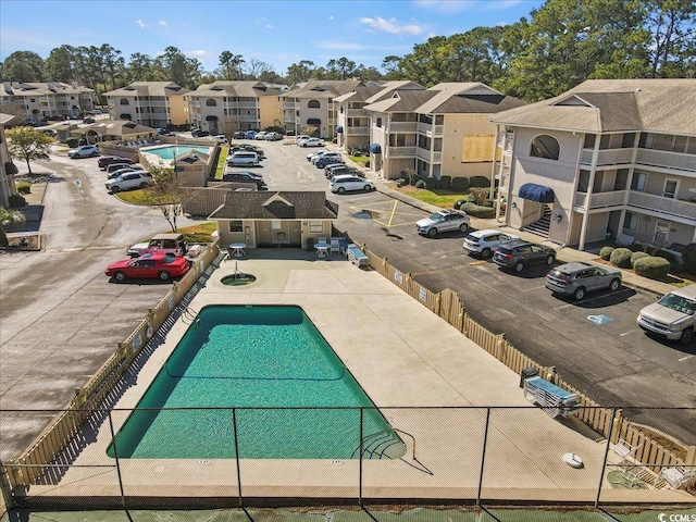 pool featuring fence and a residential view