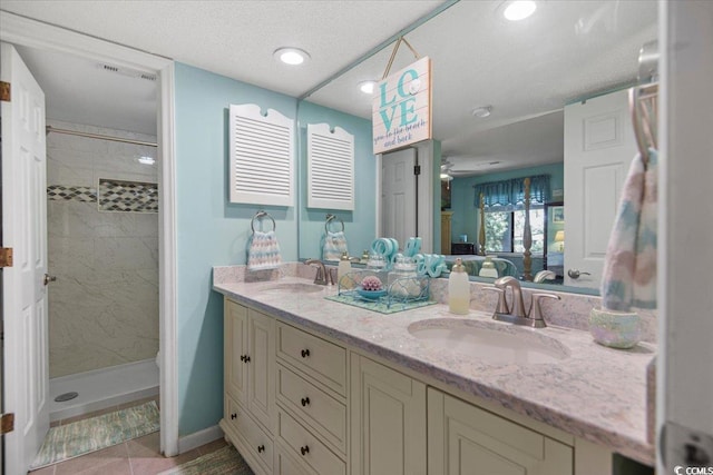 full bath with ensuite bath, a shower stall, and a sink