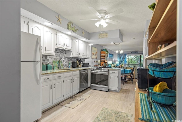 kitchen with white cabinetry, a ceiling fan, backsplash, and appliances with stainless steel finishes