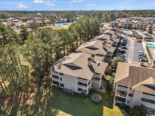drone / aerial view with a water view and a residential view