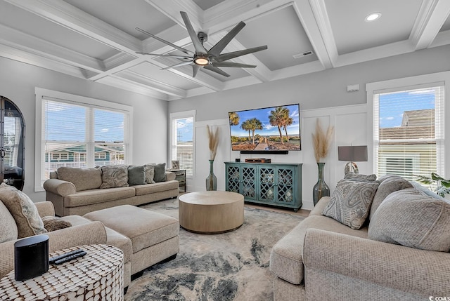 living area with visible vents, ceiling fan, wood finished floors, coffered ceiling, and beamed ceiling