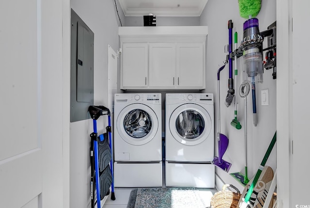 washroom with cabinet space, electric panel, crown molding, and separate washer and dryer