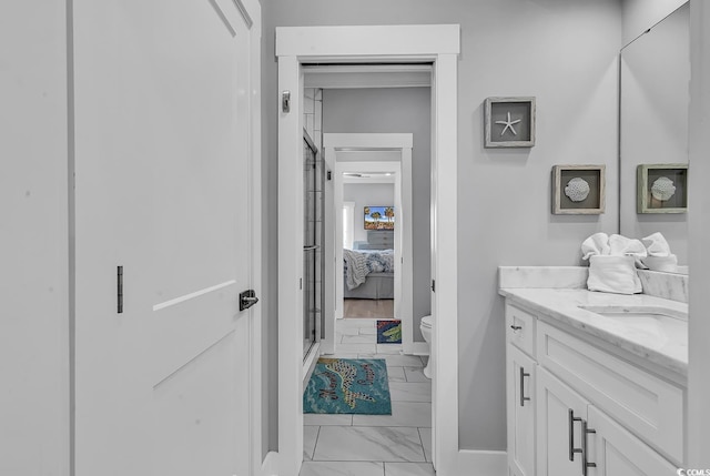 full bathroom with marble finish floor, toilet, vanity, ensuite bath, and baseboards