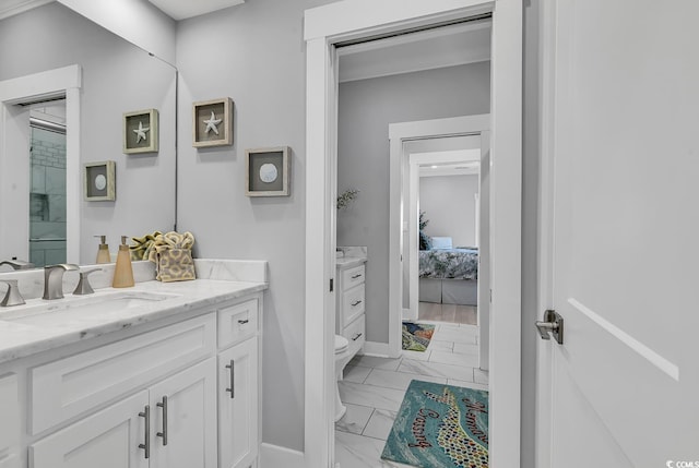 ensuite bathroom featuring toilet, marble finish floor, ensuite bath, and vanity