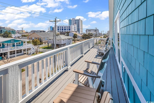 wooden terrace with a city view