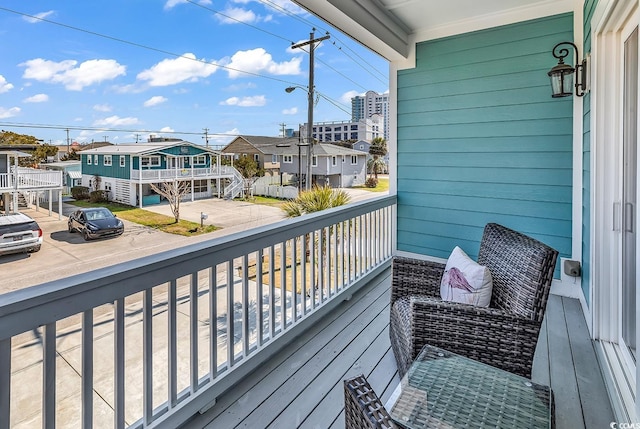 balcony featuring a sunroom and a residential view