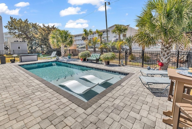 view of pool with a fenced in pool, a patio area, and fence