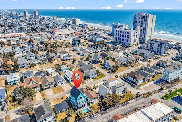 birds eye view of property with a water view and a city view