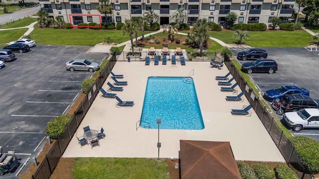 view of swimming pool featuring fence