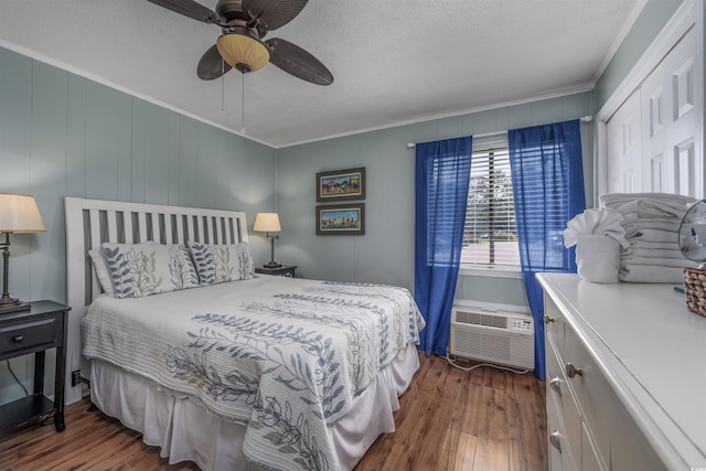 bedroom with wood finished floors, a ceiling fan, and crown molding