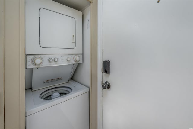 clothes washing area with laundry area and stacked washer / drying machine