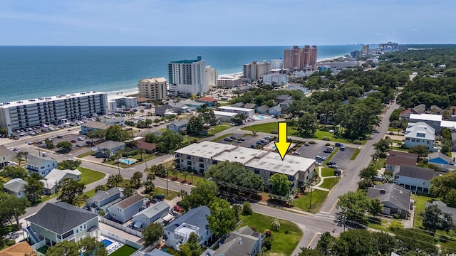 drone / aerial view featuring a water view and a view of city