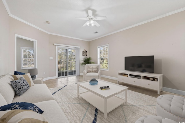 living room with visible vents, baseboards, ceiling fan, ornamental molding, and tile patterned flooring