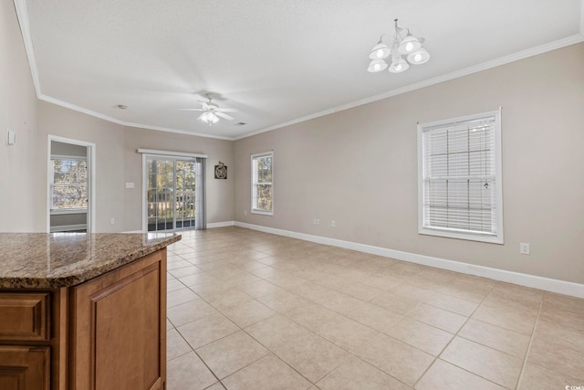 interior space featuring ornamental molding, light tile patterned flooring, baseboards, and ceiling fan with notable chandelier