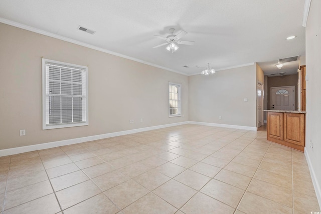 empty room with visible vents, crown molding, baseboards, and light tile patterned floors