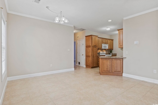 kitchen with electric range, white microwave, ornamental molding, brown cabinetry, and a chandelier