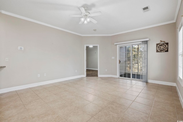 empty room with baseboards, ceiling fan, visible vents, and crown molding