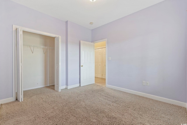 unfurnished bedroom featuring carpet, baseboards, and a closet