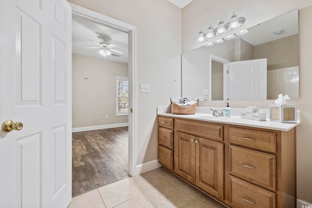 bathroom featuring vanity, baseboards, a ceiling fan, and tile patterned floors