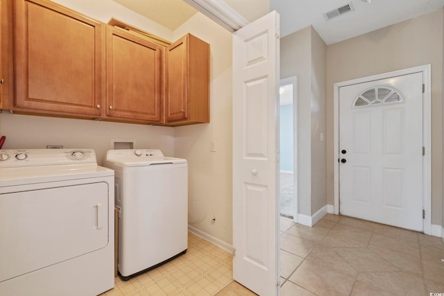 laundry area with cabinet space, baseboards, visible vents, and washer and dryer