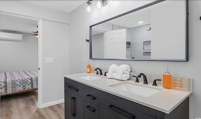 214 2nd Ave S, North Myrtle Beach, SC 29582 - full bath with a wall mounted air conditioner, double vanity, wood finished floors, a ceiling fan, and a tile shower
