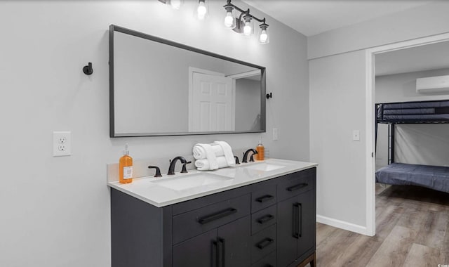 214 2nd Ave S, North Myrtle Beach, SC 29582 - ensuite bathroom with an AC wall unit, double vanity, and wood finished floors