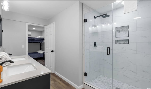 214 2nd Ave S, North Myrtle Beach, SC 29582 - bathroom featuring a shower stall, wood finished floors, and double vanity