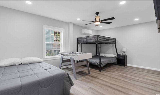 214 2nd Ave S, North Myrtle Beach, SC 29582 - bedroom with an AC wall unit, light wood-type flooring, recessed lighting, and a ceiling fan