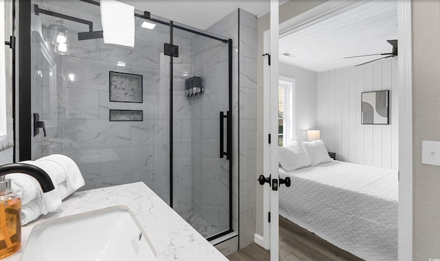 214 2nd Ave S, North Myrtle Beach, SC 29582 - ensuite bathroom featuring wood finished floors, a marble finish shower, vanity, and ceiling fan