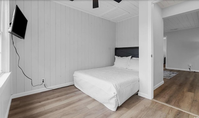 214 2nd Ave S, North Myrtle Beach, SC 29582 - bedroom featuring wood finished floors, wooden walls, and a ceiling fan