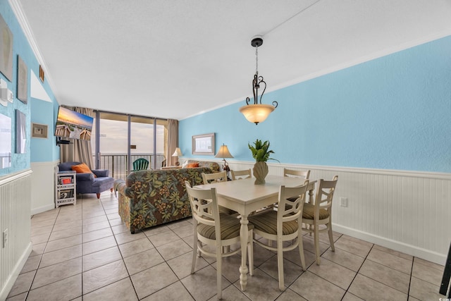 9400 Shore Dr Unit 722, Myrtle Beach, SC 29572 - dining area with light tile patterned flooring, wainscoting, and ornamental molding