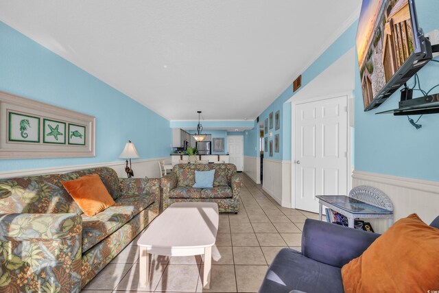 9400 Shore Dr Unit 722, Myrtle Beach, SC 29572 - living area with wainscoting, light tile patterned flooring, and ornamental molding