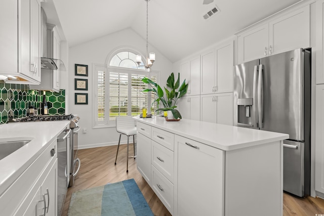 kitchen featuring light wood-style flooring, a center island, light countertops, visible vents, and stainless steel appliances