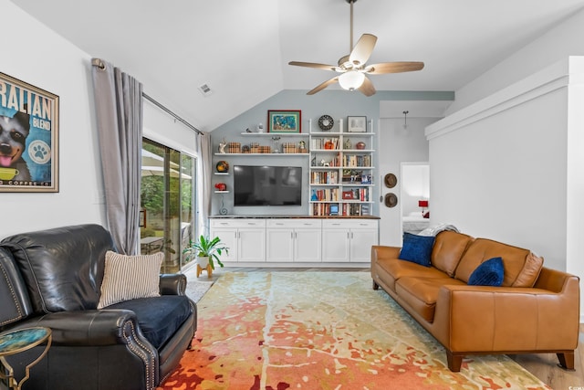 living room featuring visible vents, light wood-type flooring, a ceiling fan, and vaulted ceiling