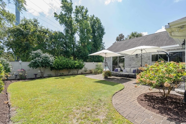 view of yard with outdoor lounge area, a patio, and a fenced backyard