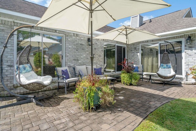rear view of house with outdoor lounge area, a chimney, a shingled roof, and a patio area