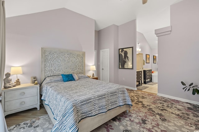 bedroom with baseboards, high vaulted ceiling, and connected bathroom