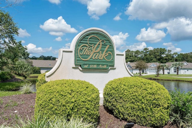 community / neighborhood sign featuring a water view